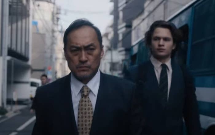 Ansel Elgort as Jake and Ken Watanabe as Katagiri walking out of a police bus about to confront some Yakuza