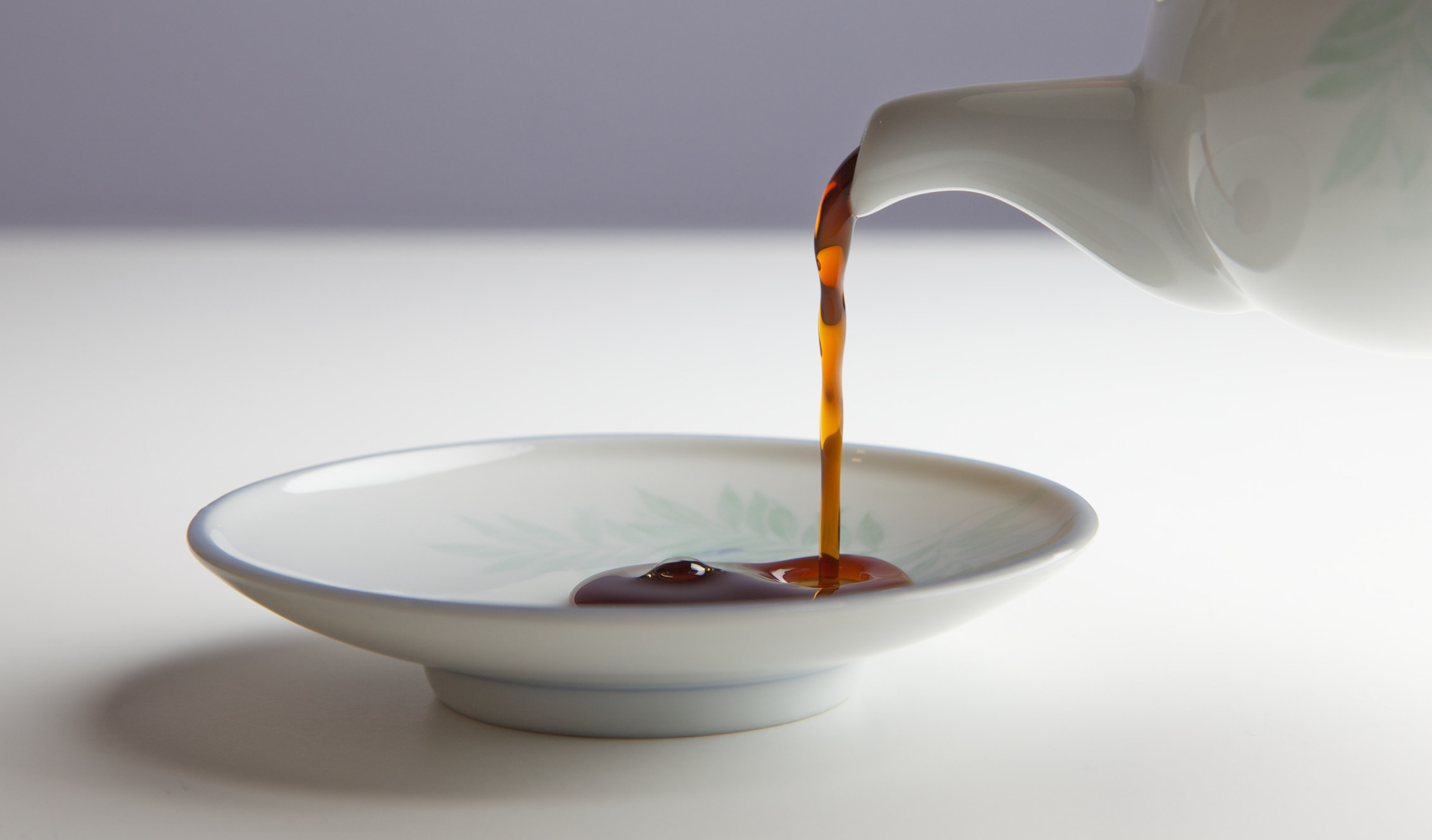 Pouring soy sauce into a bowl.