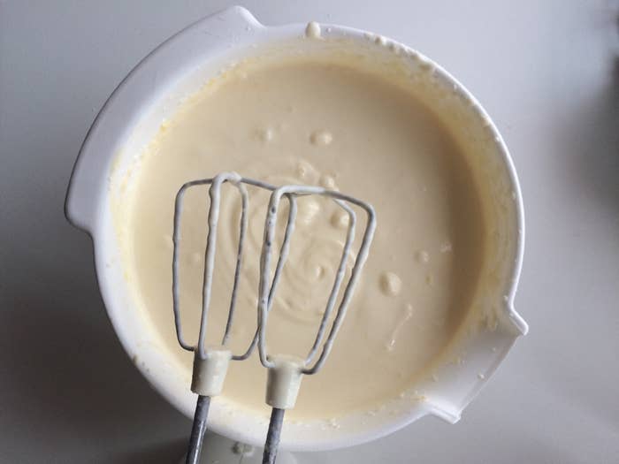 Close-up of a bowl of batter with hand mixer.