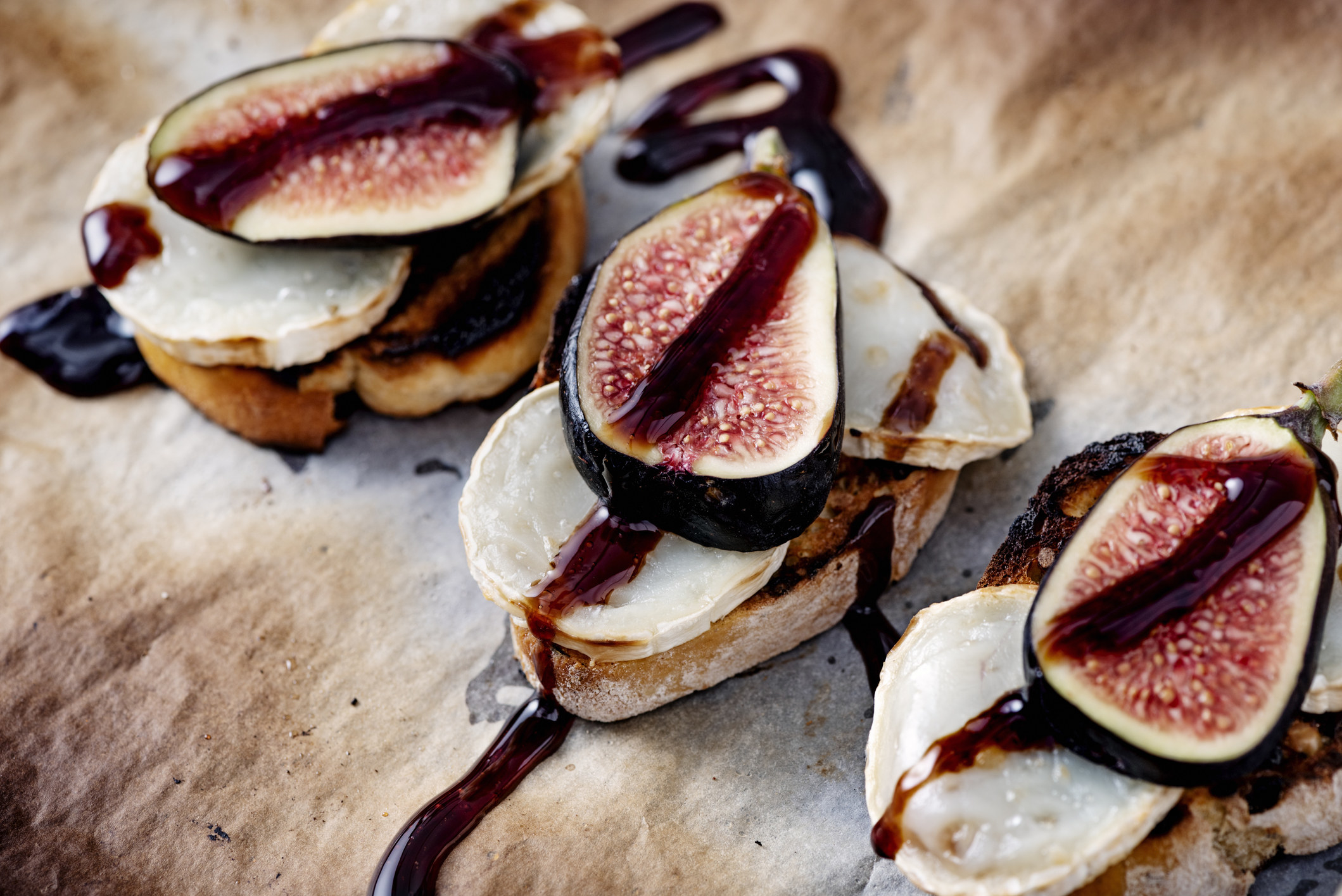 Fig and cheese toasts with balsamic drizzle.