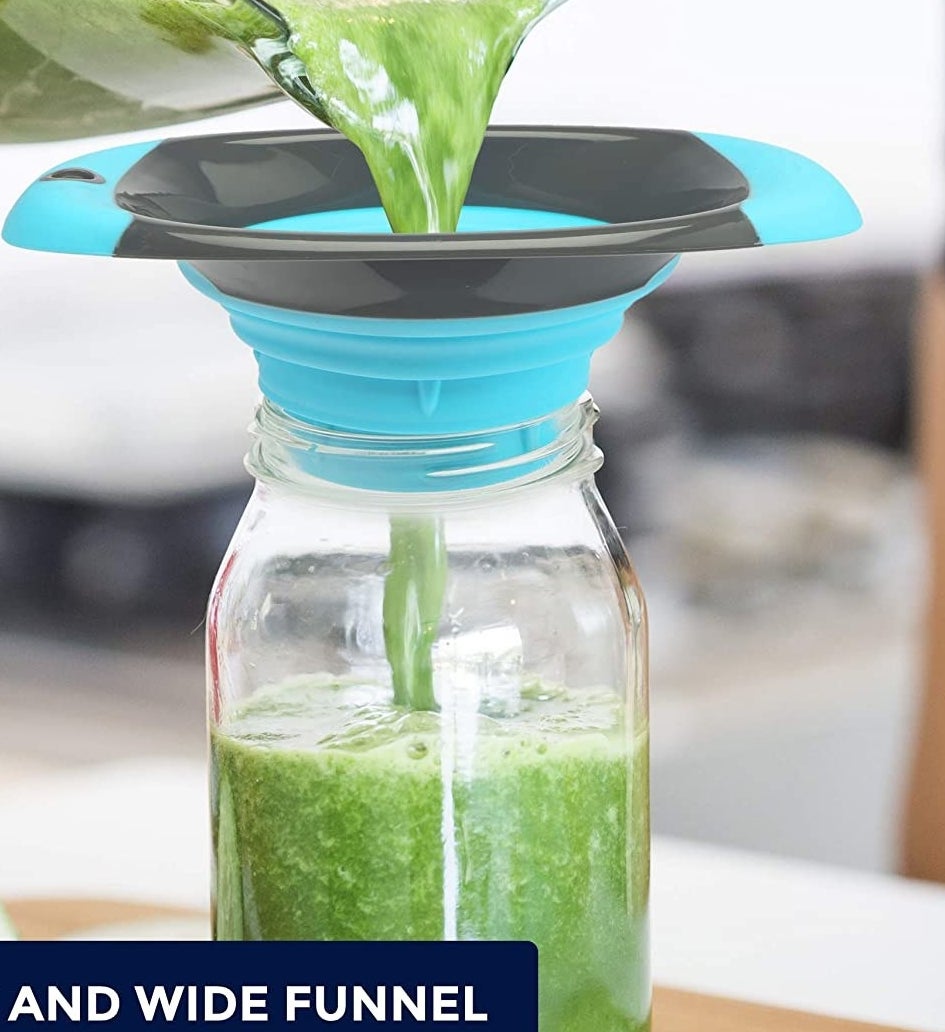 green juice flowing from one jar through the funnel and into a glass bottle