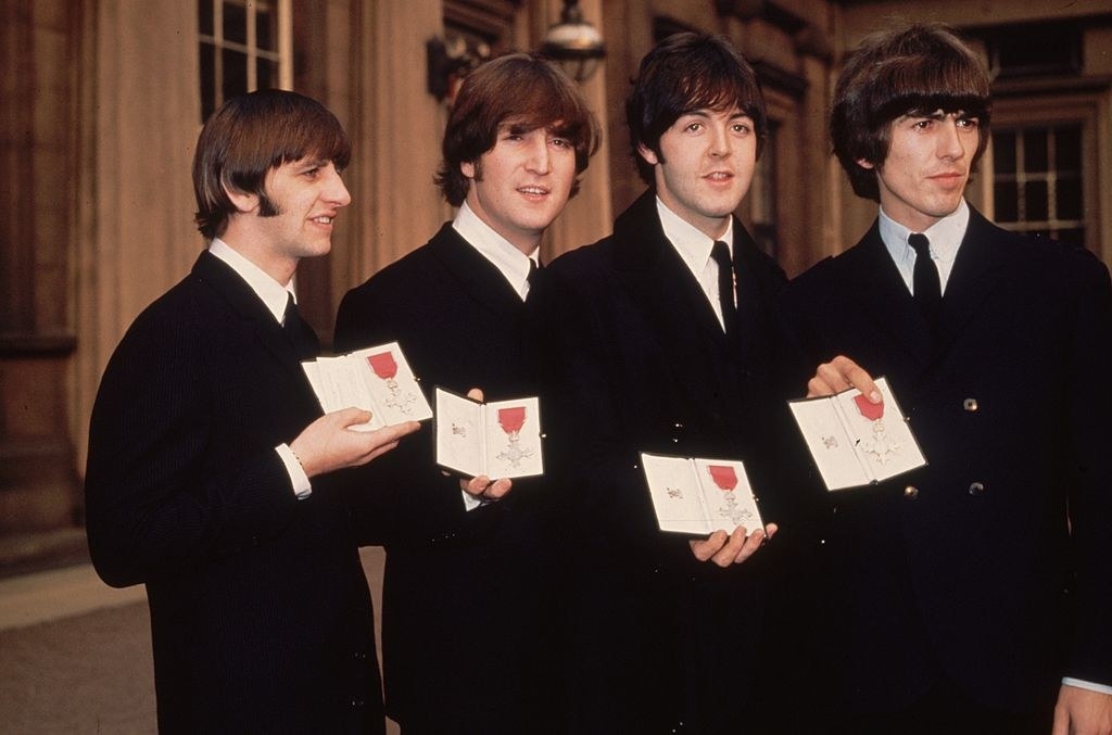 The Beatles holding their MBEs