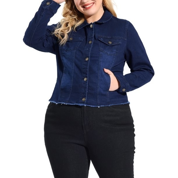 Model wearing dark wash denim jacket with black jeans