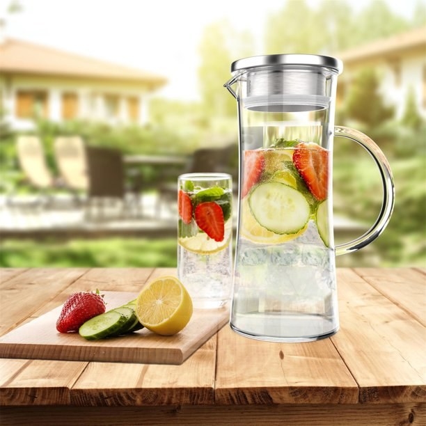 The glass carafe with infused water inside
