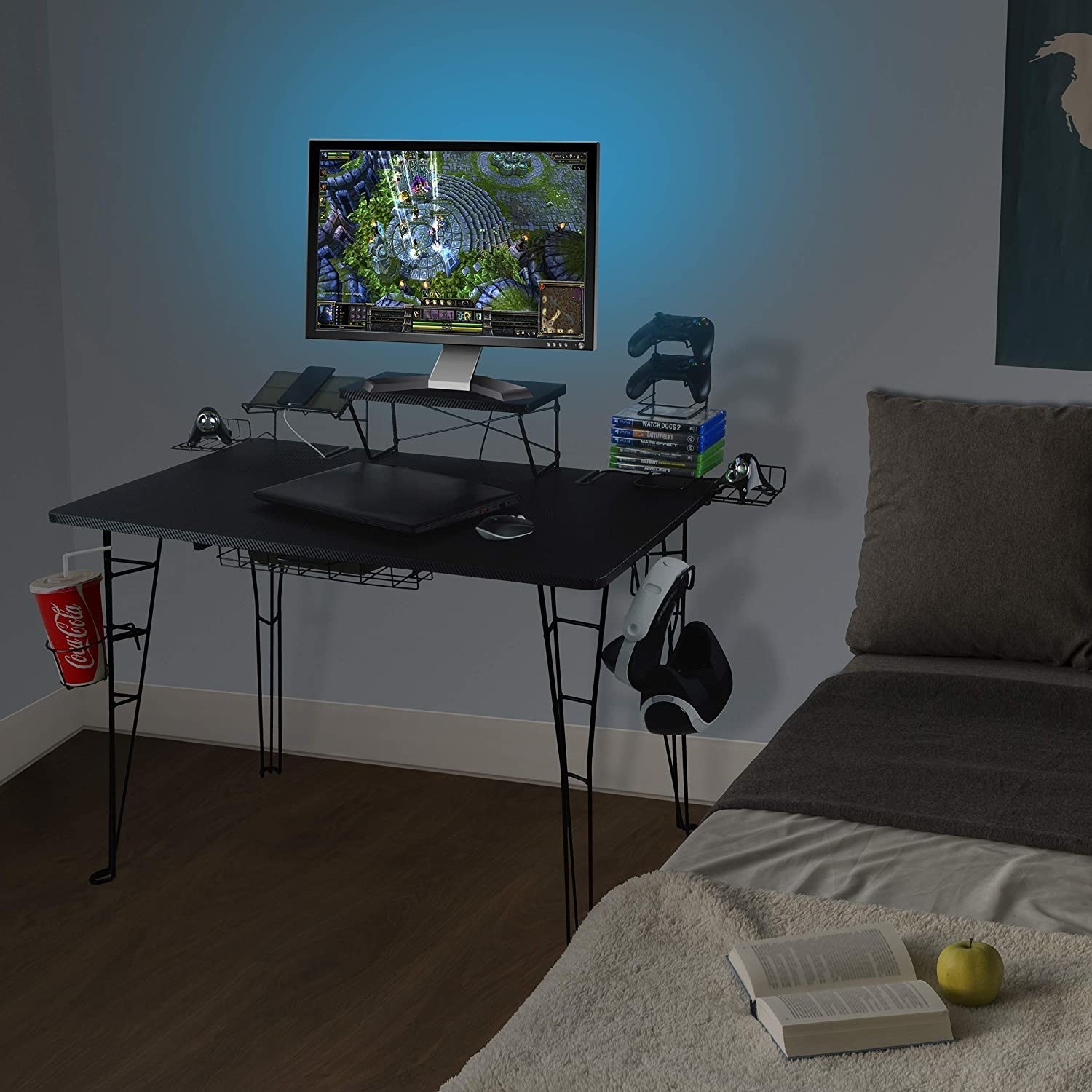 The gaming desk in a bedroom with several games and accessories on it