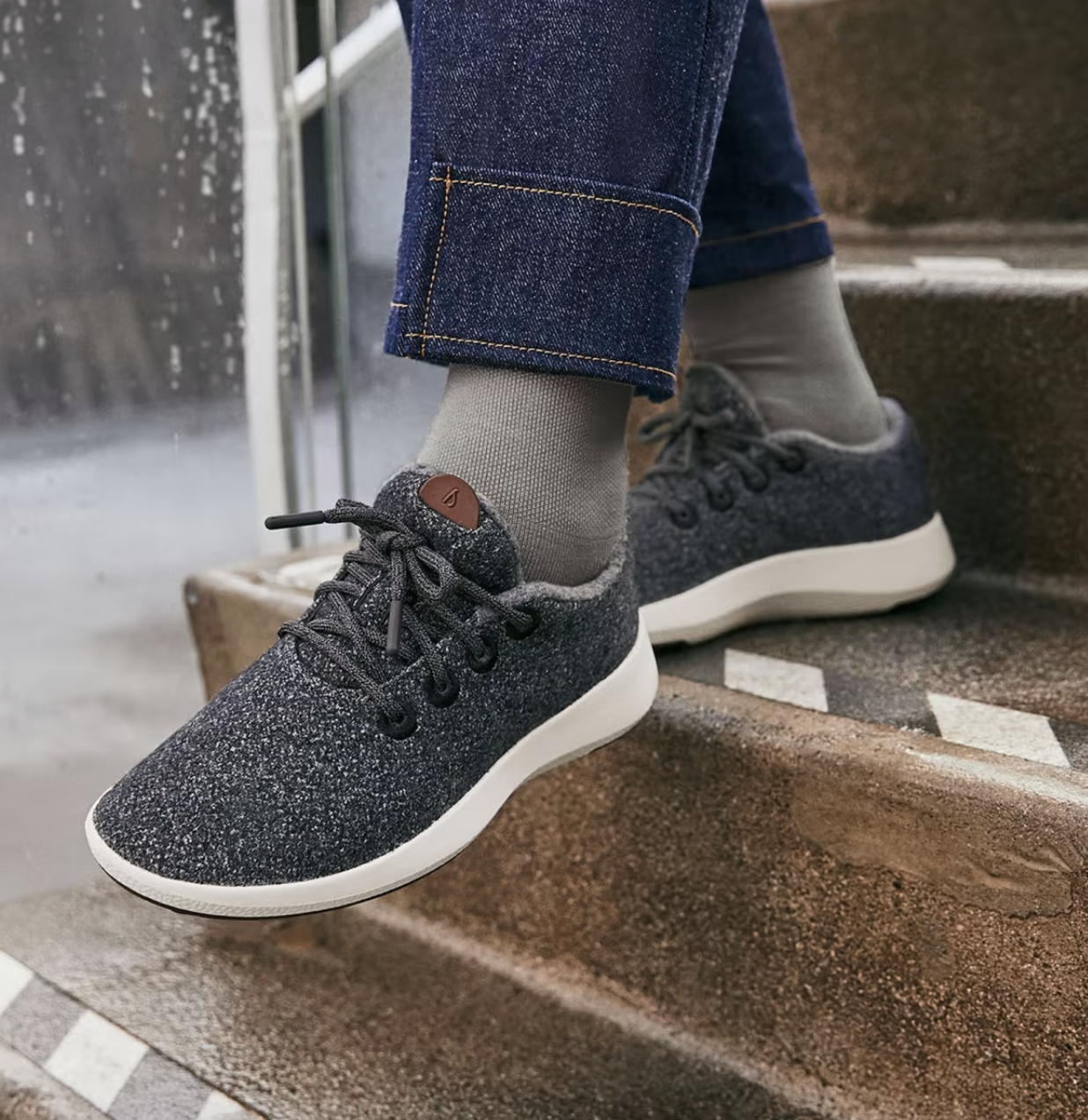 a person wearing the waterproof wool sneakers on a rainy day