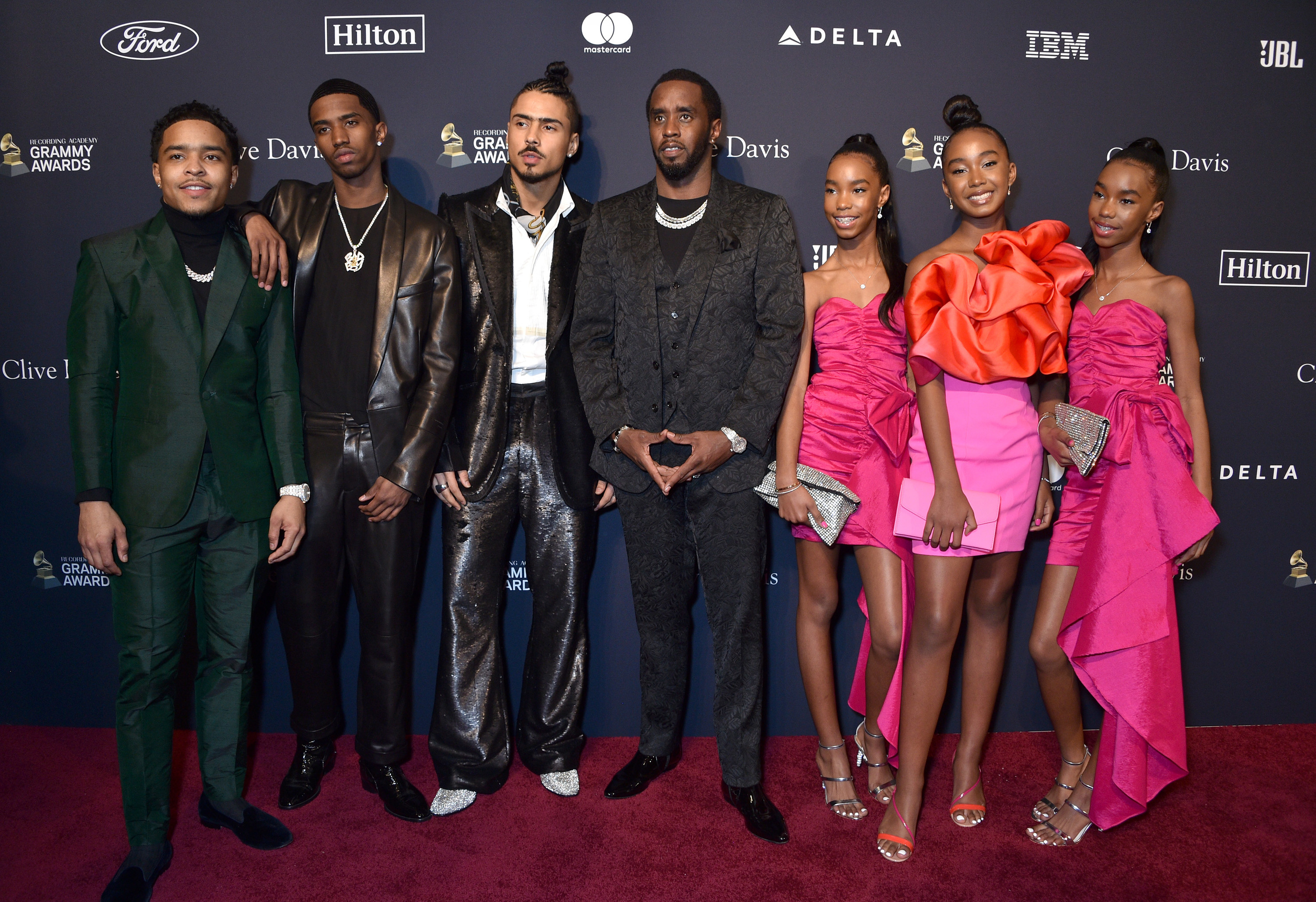 Diddy poses with his children on a red carpet