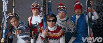 One Direction posing for a photo shoot in ski attire