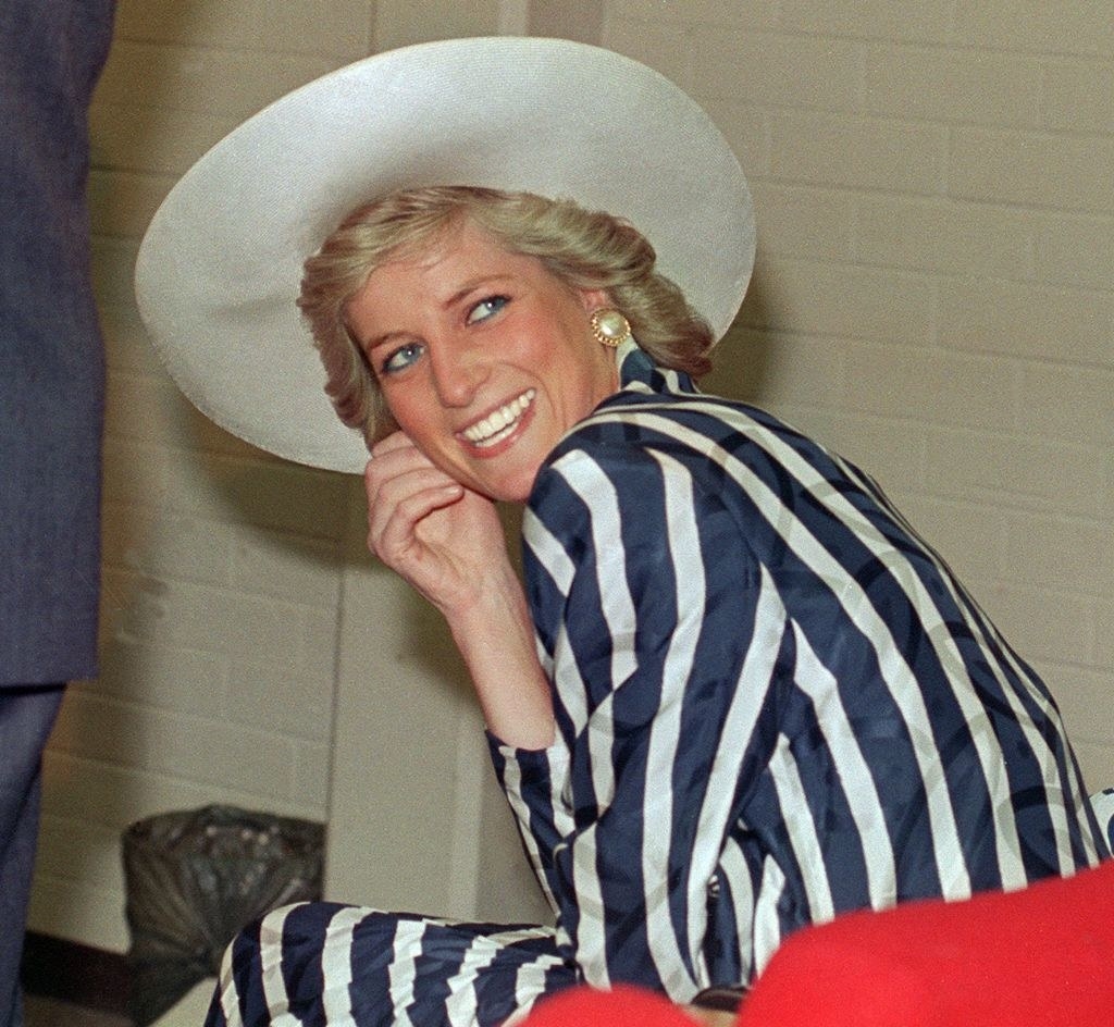 Princess Diana laughing and looking behind her shoulder