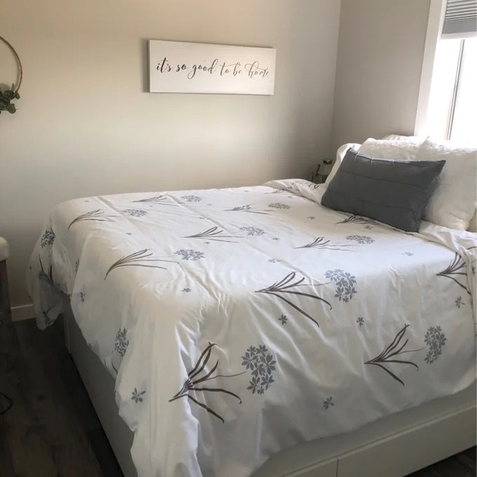 the white duvet with small flower detailing on a bed