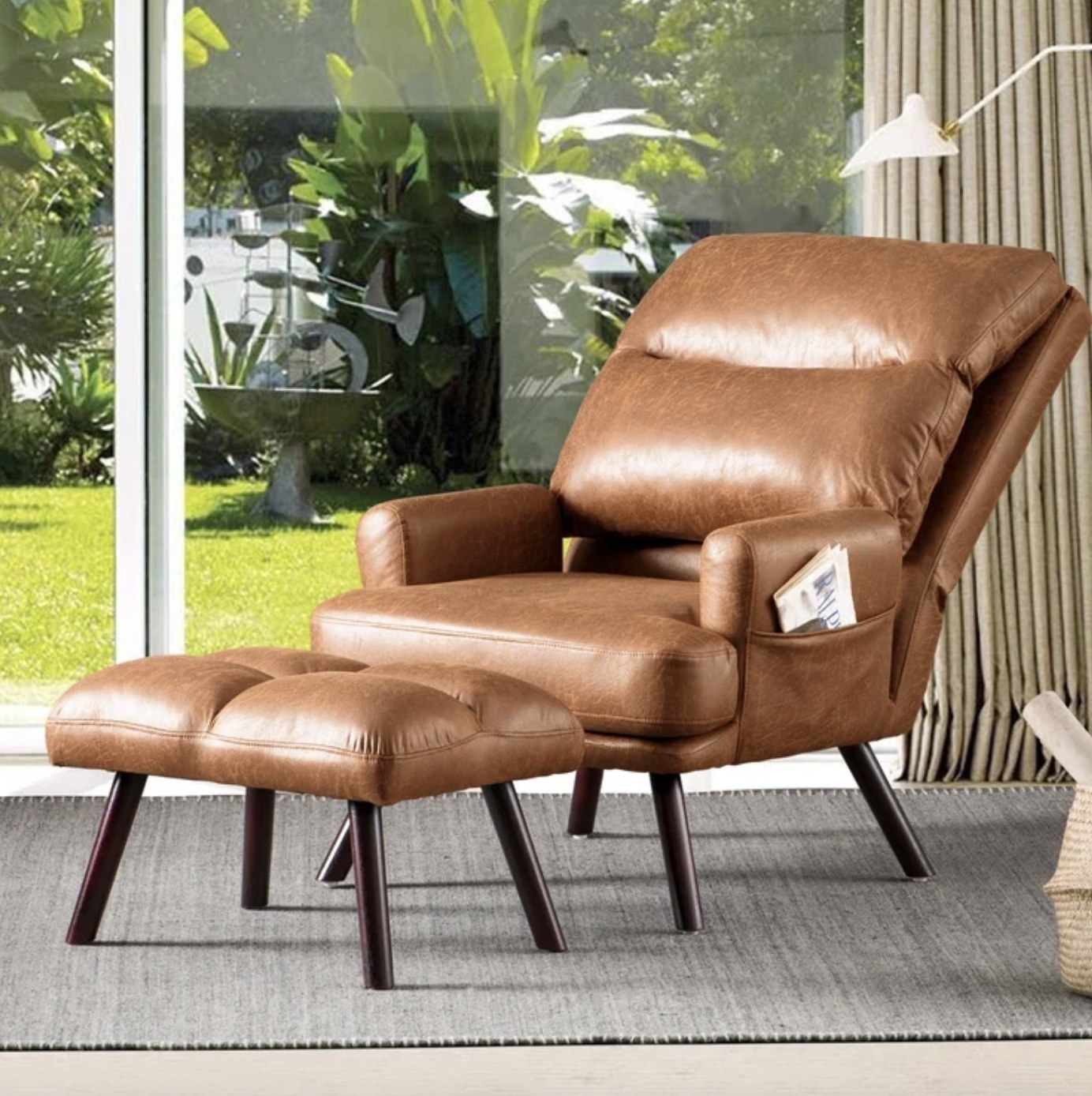 The light brown recliner has a large back cushion and smaller cushioning on the ottoman