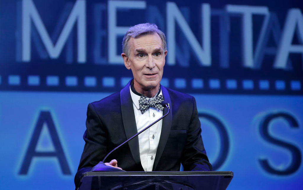 Bill Nye speaking at a podium