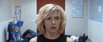 Scarlett Johannsen as Lucy making an entire hallway of men fall down unconscious with a wave of her hand