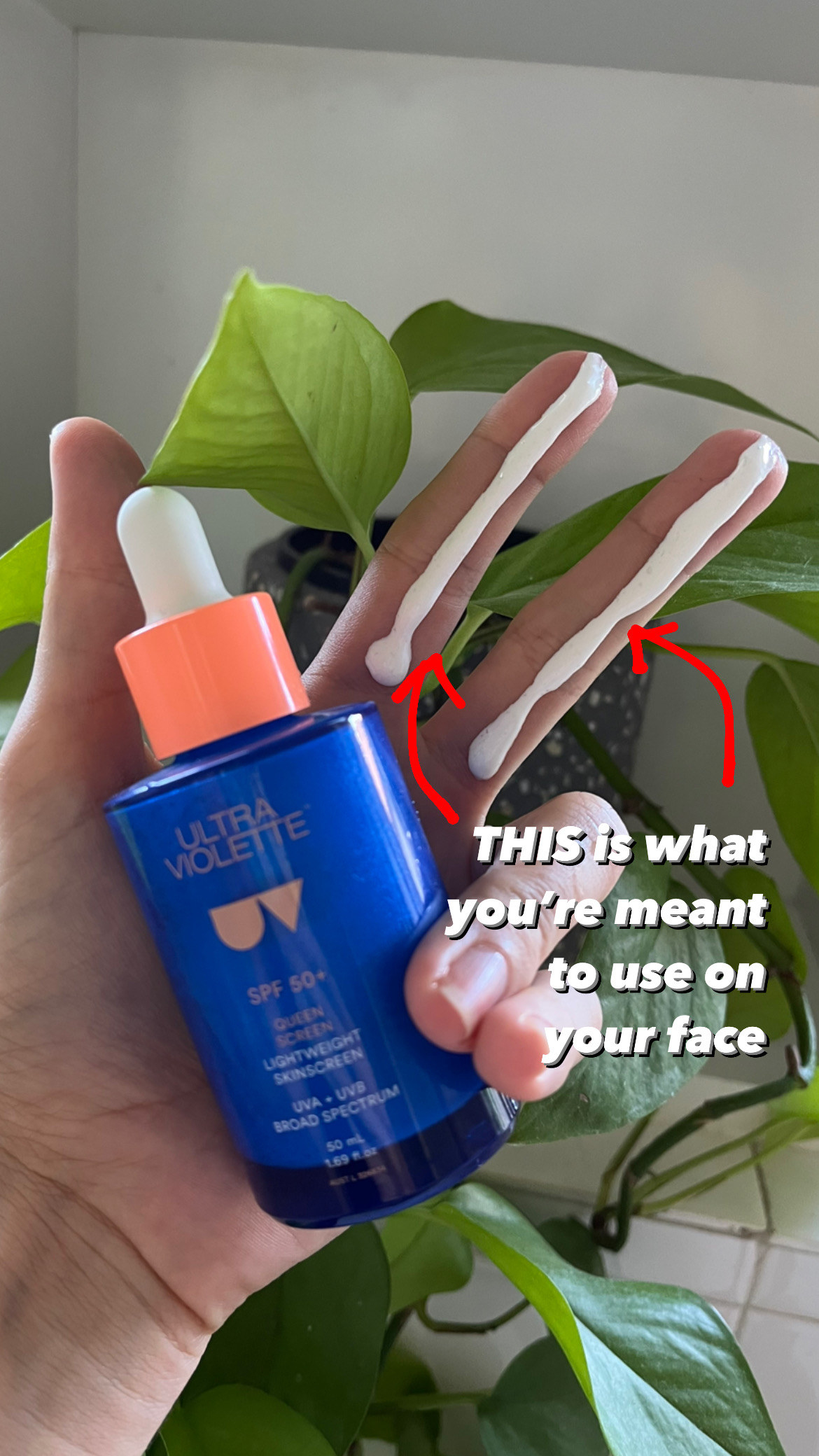 Person holding a bottle of Ultra Violette SPF 50+ skinscreen with two long strips of it on two fingers, with the text "THIS is what you're meant to use on your face"