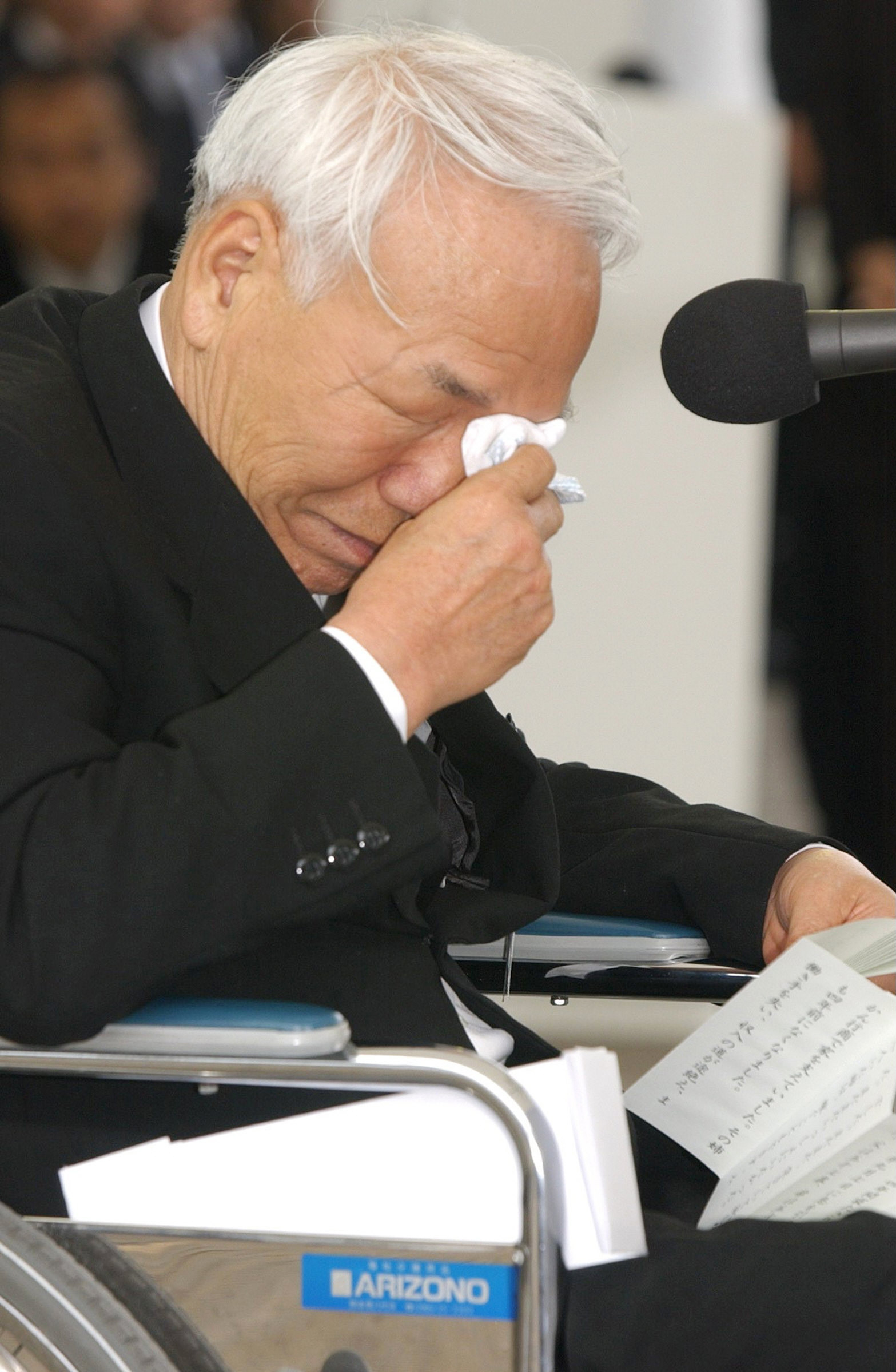 Minamata disease patient Tsuginori Hamamoto cries as he delivers a speech at a 2006 event bringing awareness to the worst health disasters in Japanese history