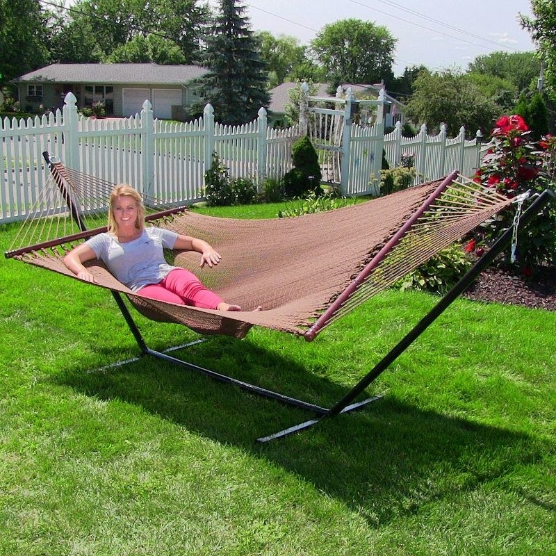 a two-person hammock with woman laying on one side of it