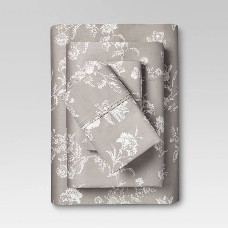 grey and white floral printed sheets folded