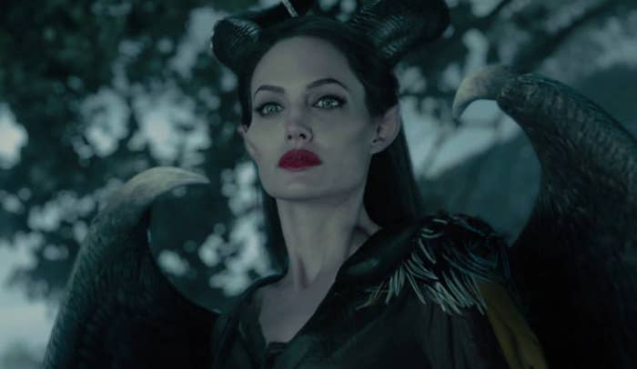 A close up of Maleficent as she wears bright lipstick