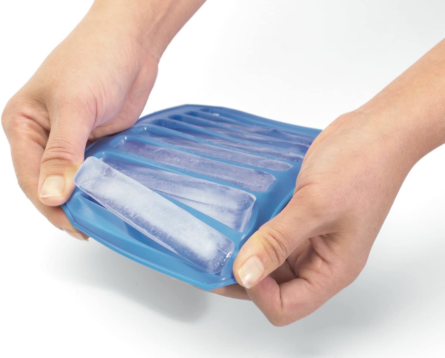 A person removing an ice cube from its tray