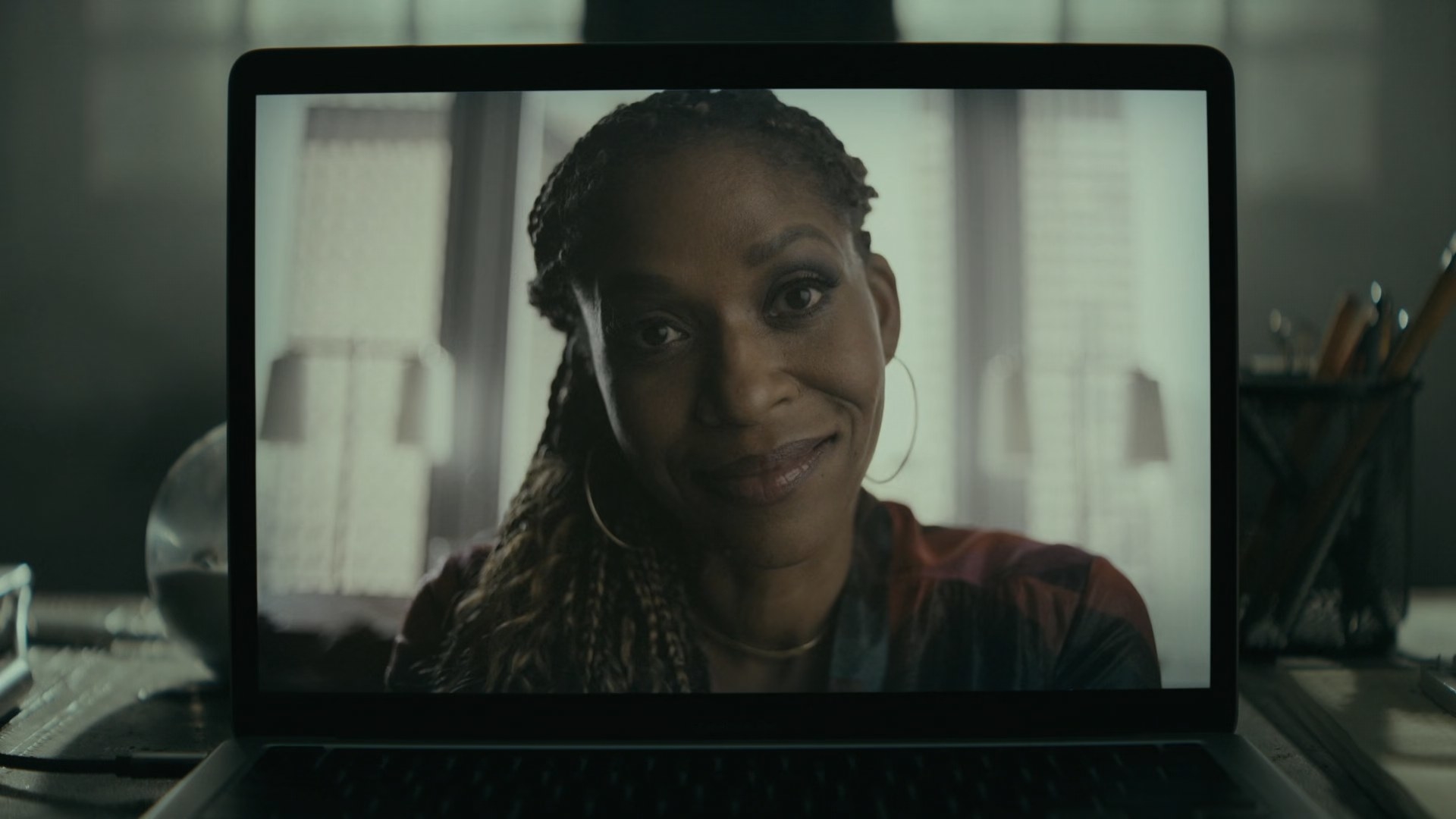 Merrin Dungey&#x27;s face appears on the screen of a laptop in a video call