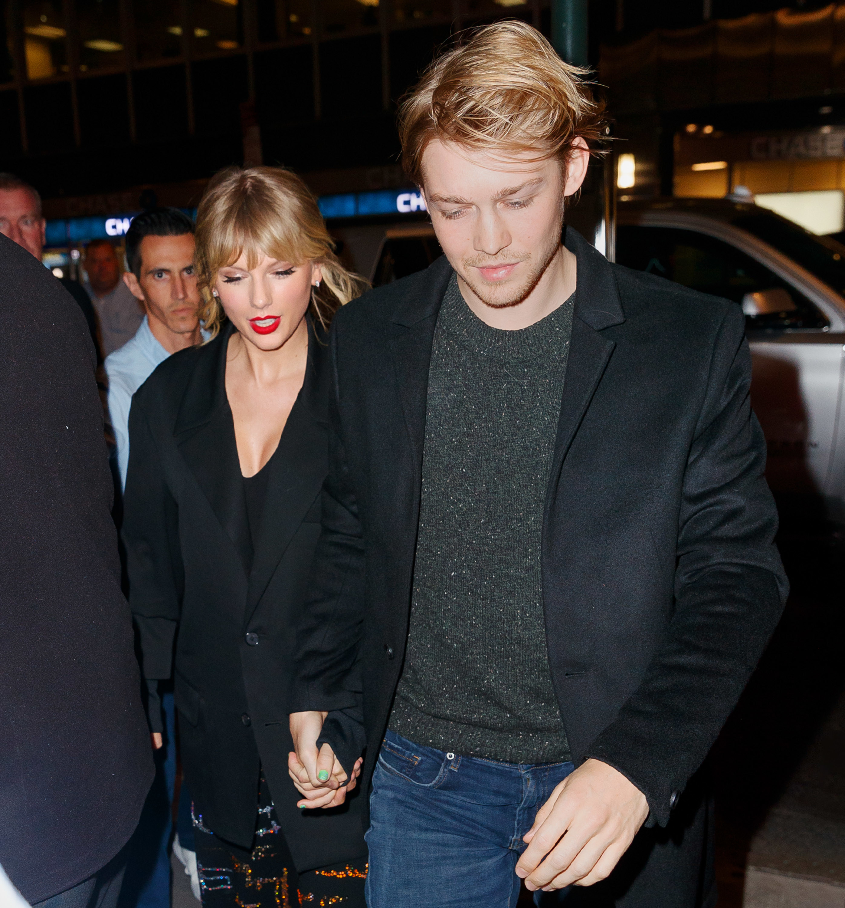 Taylor and Joe walking and holding hands