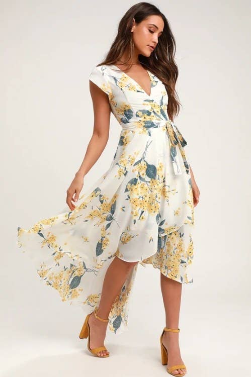 An image of a model wearing a floral high-low dress with cap sleeves and
