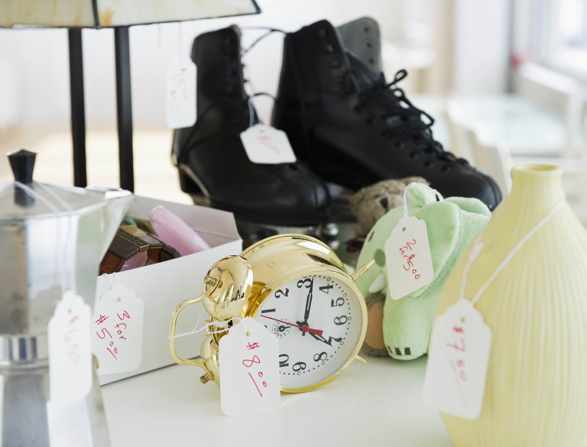 Various objects for sale, like a clock, vase, and shoes