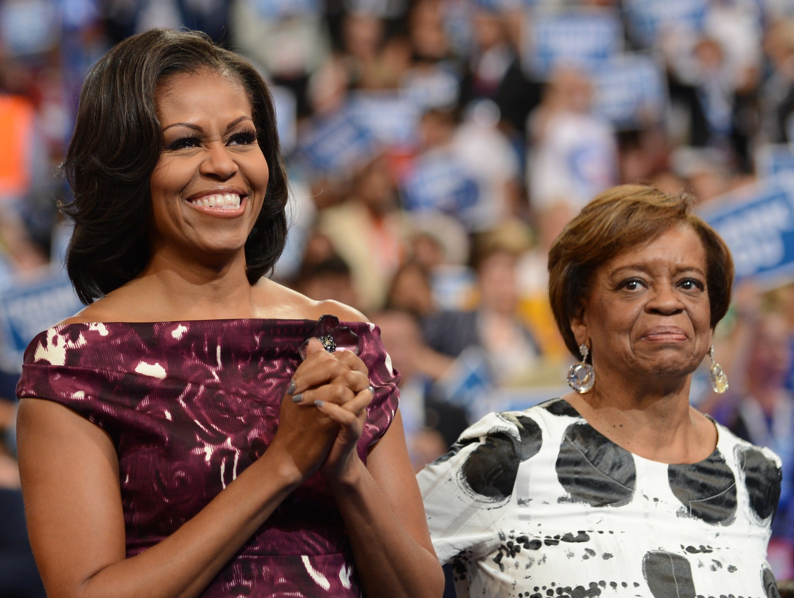 Michelle stands next to her mom at an event