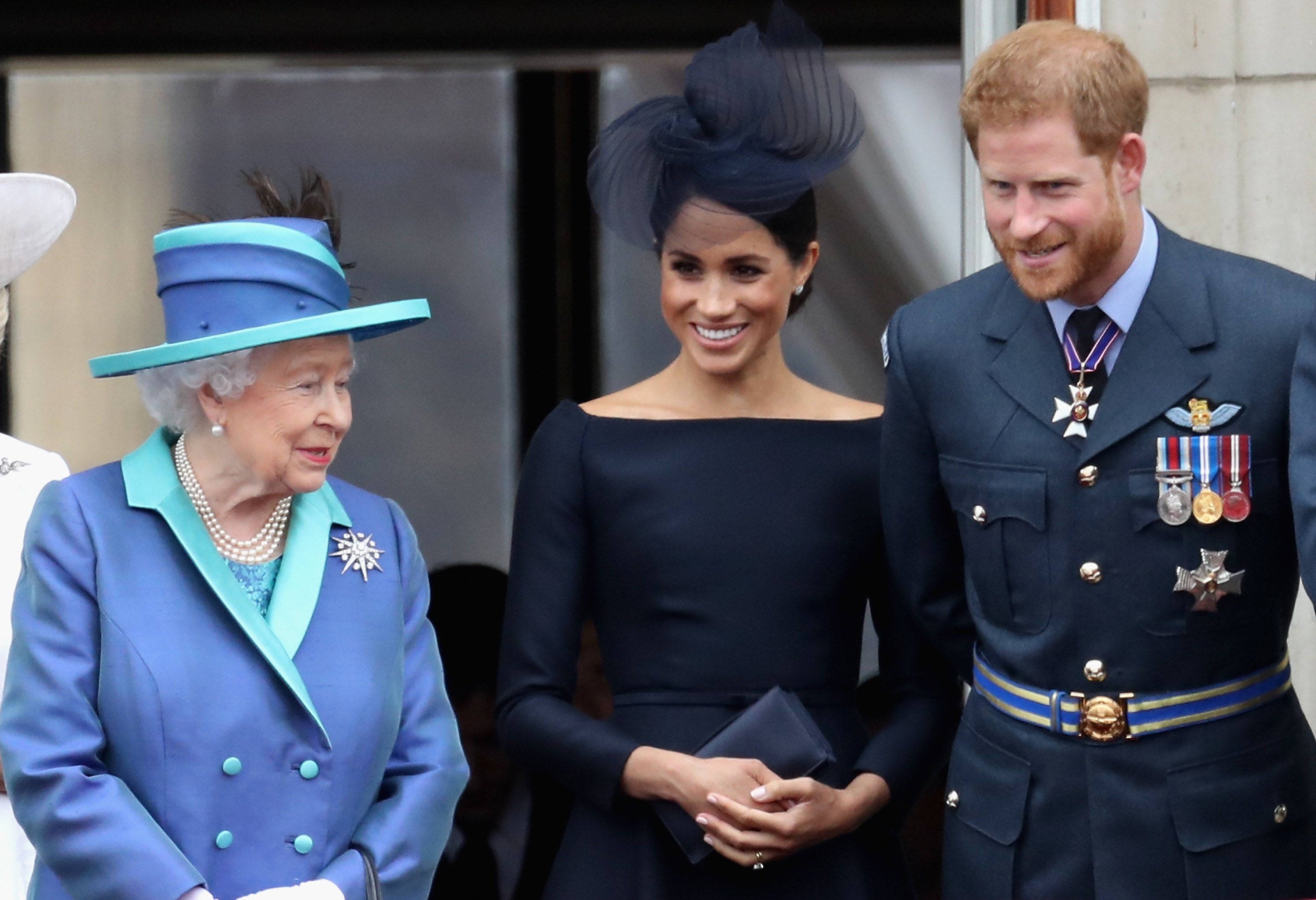 A closeup of Meghan and Harry and the Queen