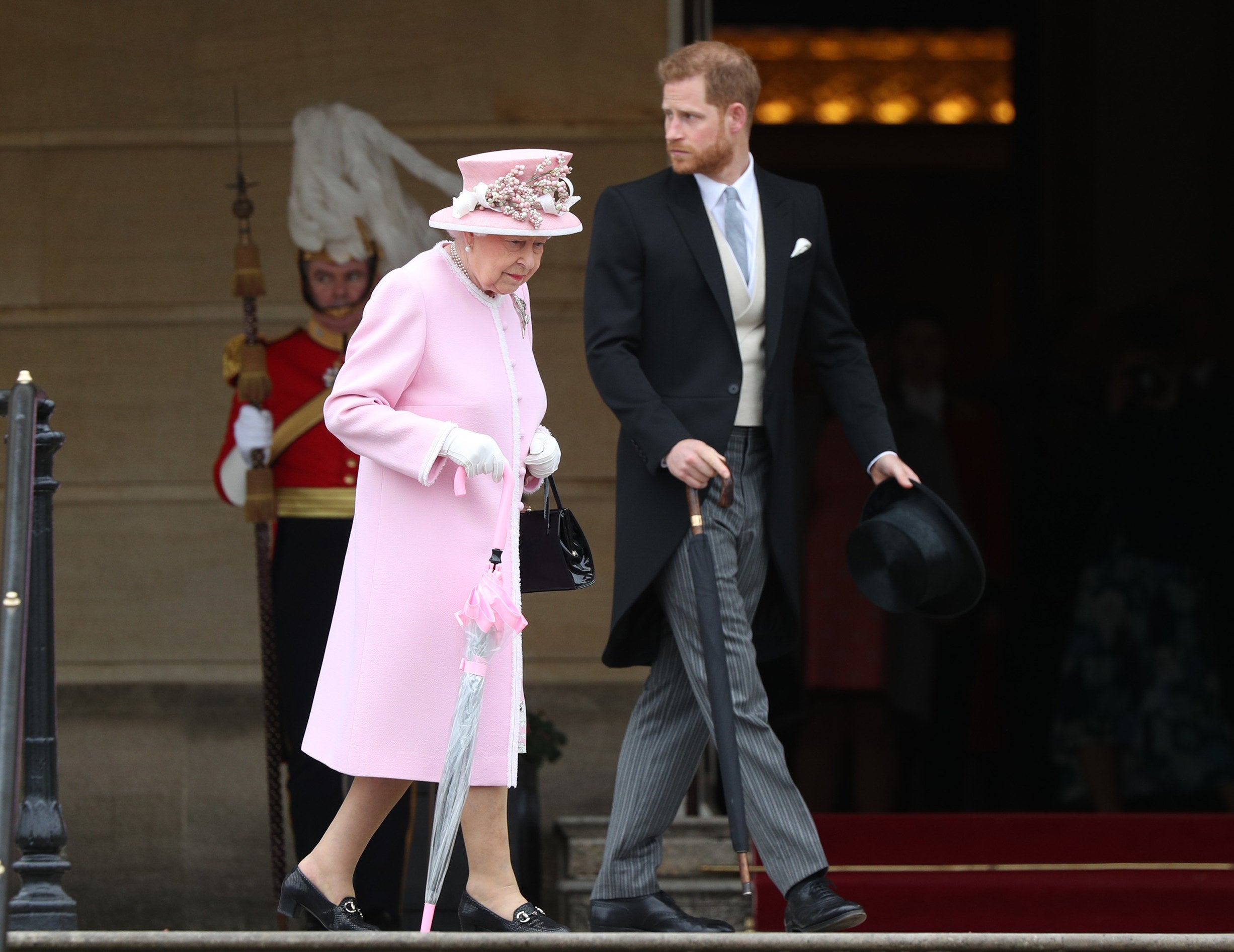 Harry walks alongside the queen