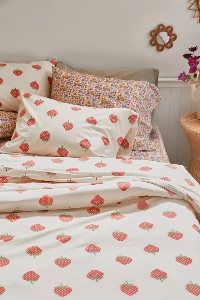 The strawberry printed duvet on a bed in a bedroom