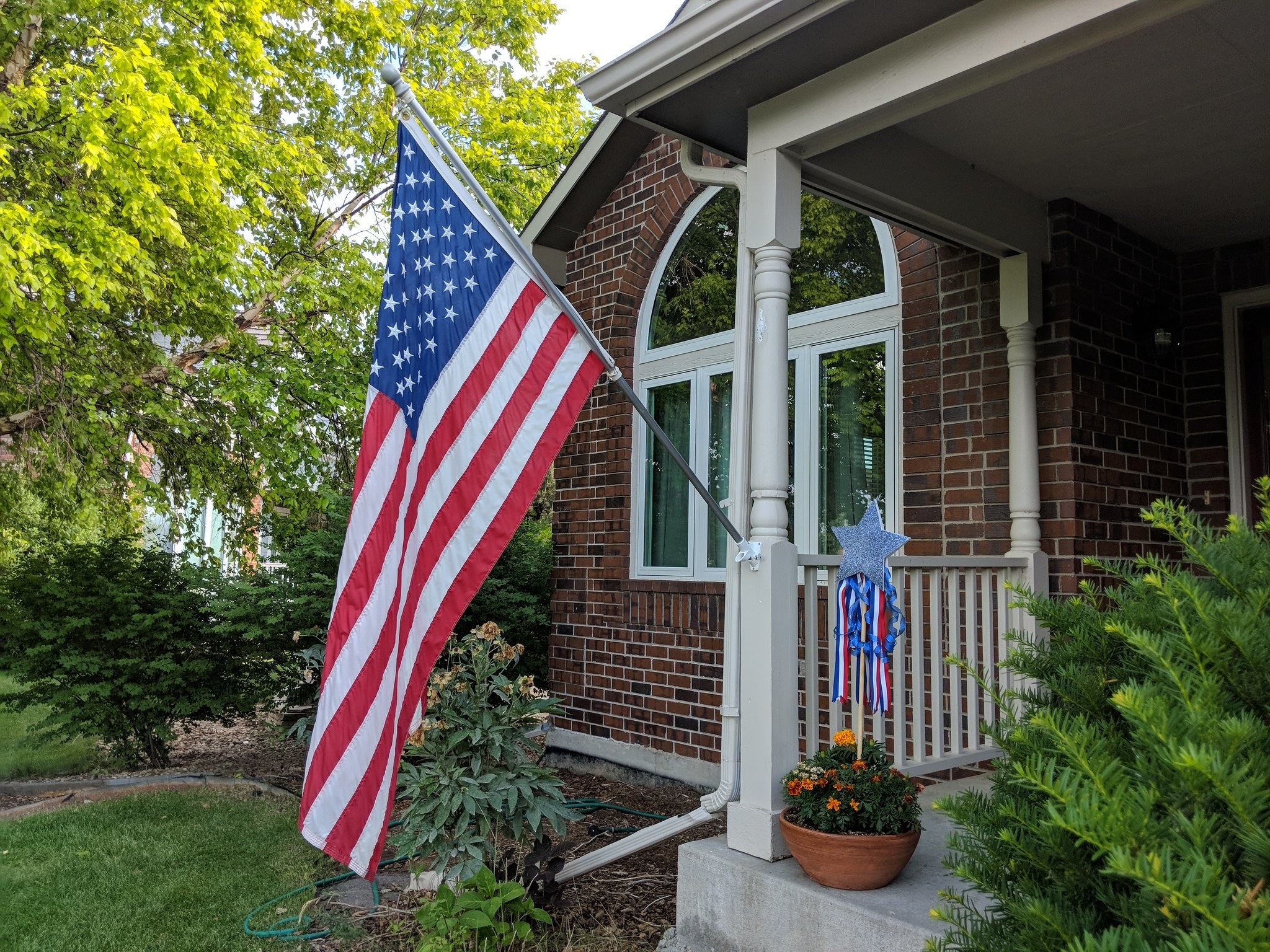 The USA flag hanging on someone&#x27;s porch