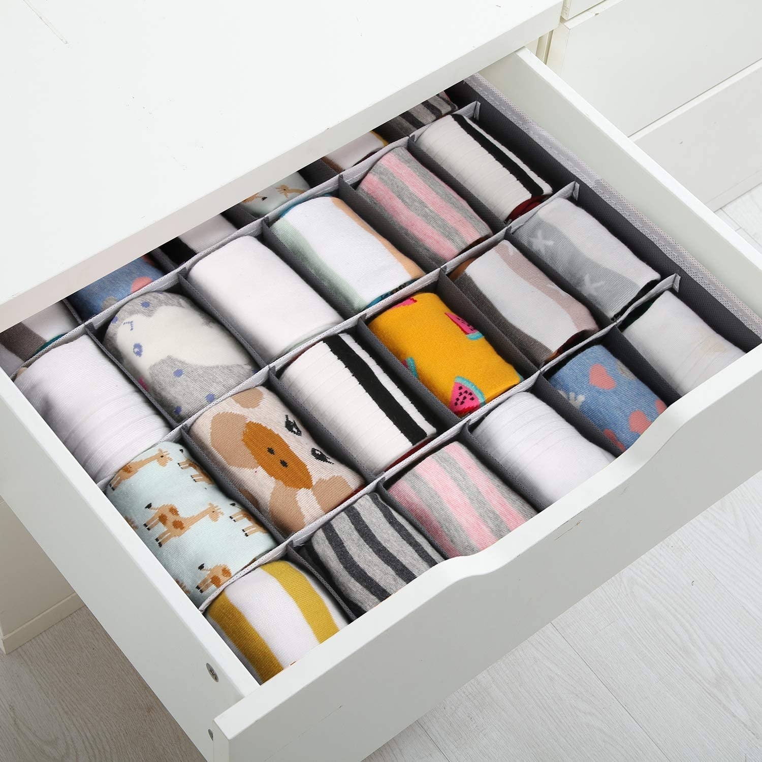 the drawer dividers dividing rolled up socks in a drawer