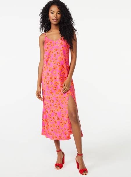 model wearing the bright pink and orange floral dress