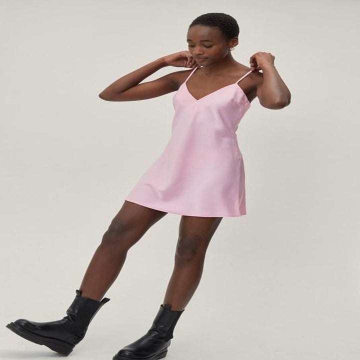 model in a short pink satin slip dress