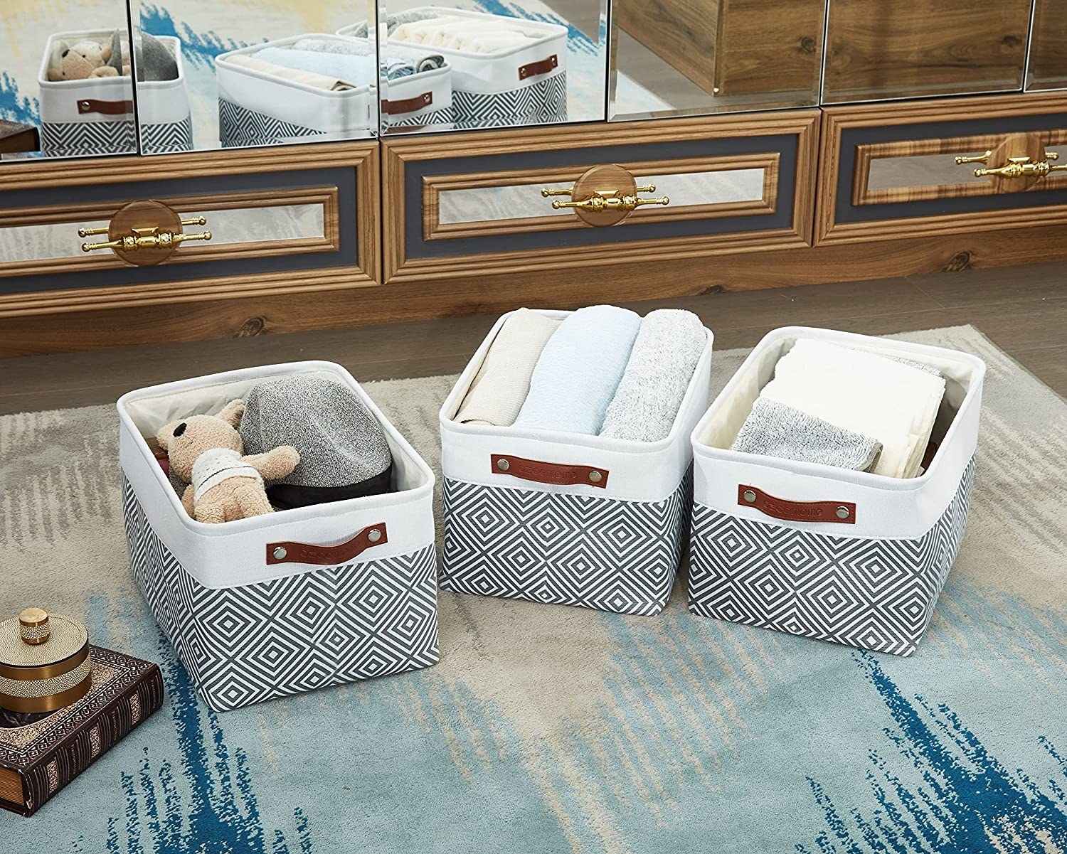 three stylish storage baskets with toys and towels in each