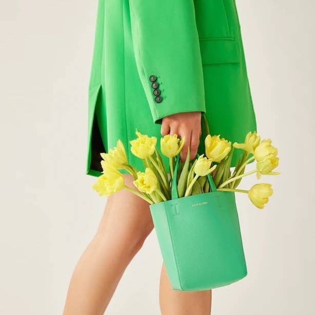 A person carrying the bag with flowers in it