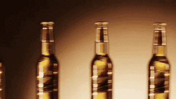 A row of Miller Genuine Draft bottles appears as the beer is poured into a glass