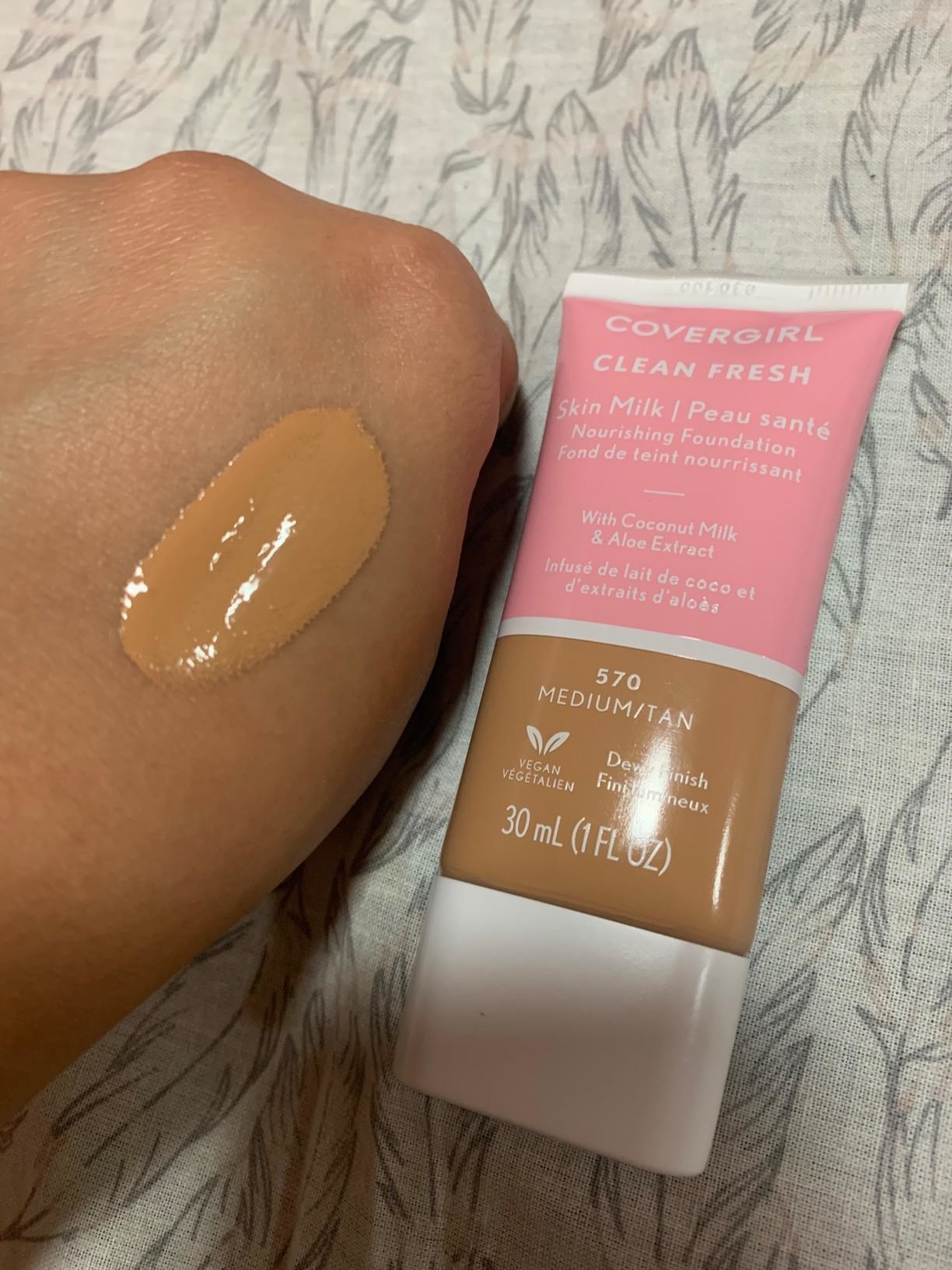 Reviewer with Covergirl Clean Fresh Skin Milk Foundation on hand