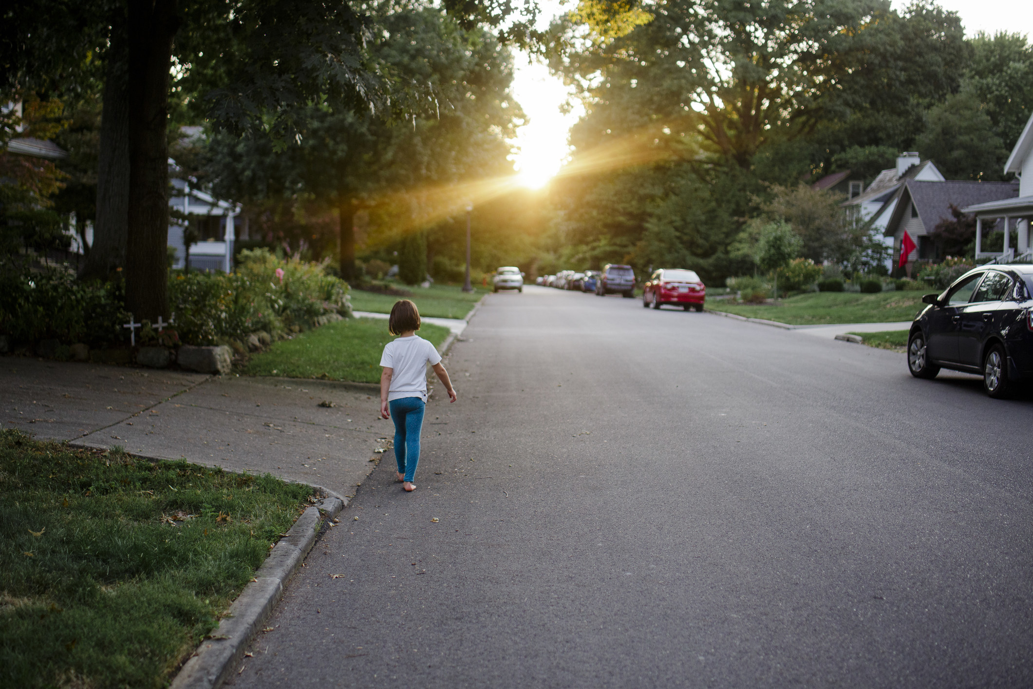 a child walking down the neighborhood