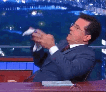 Stephen Colbert pouring a box of Oreos into his mouth