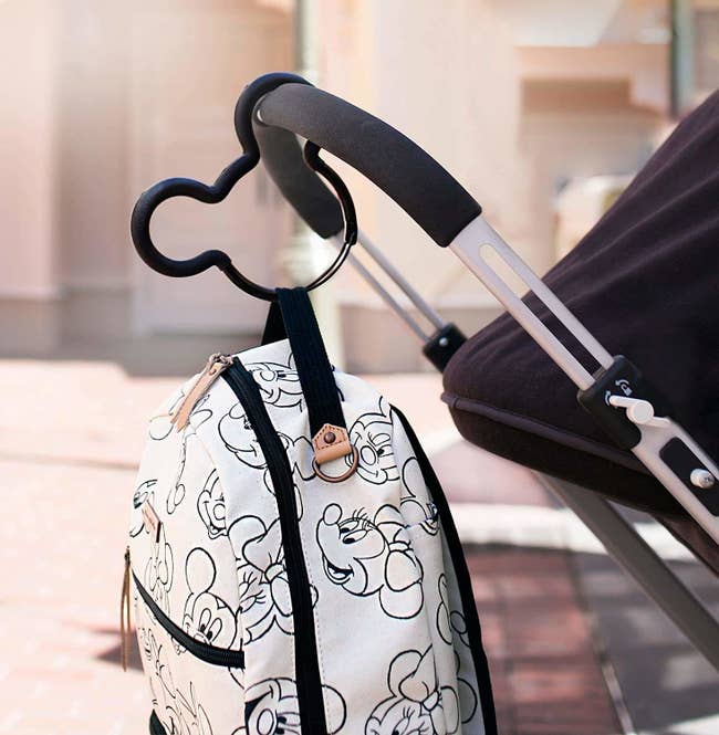 The Mickey Mouse shaped stroller hook carrying a bag