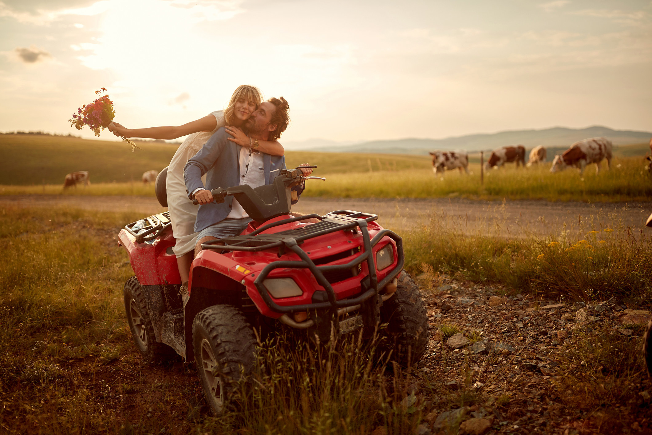 a couple kissing on a tractor