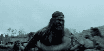 Amleth walking through the village with his sword out