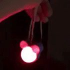 reviewer's gif of the flashing led necklace