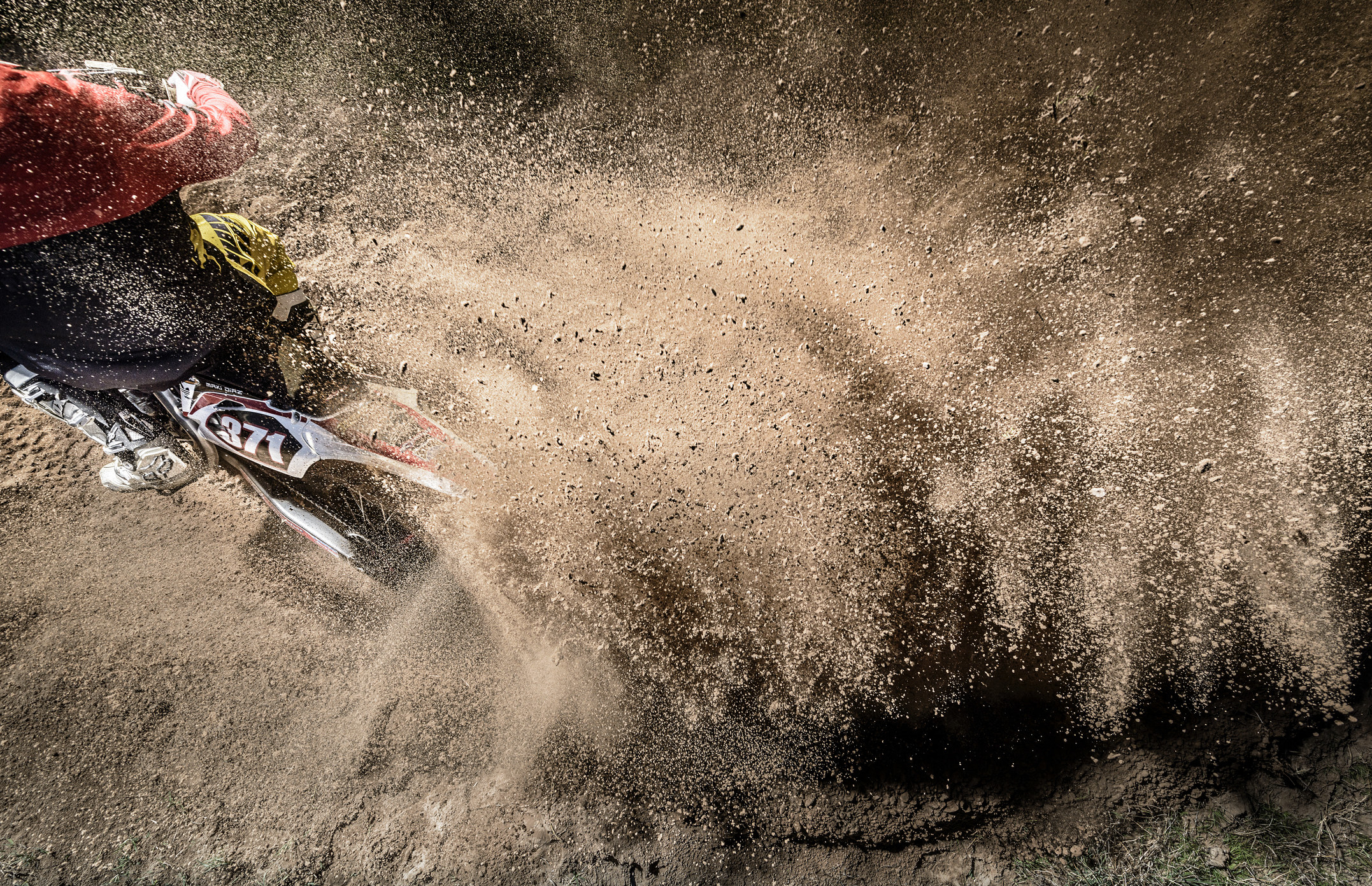 a dirt bike kicking up dirt