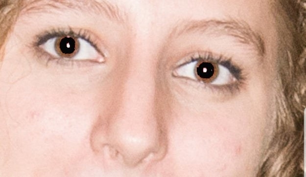 close up of the eyes with huge black dots as the pupils