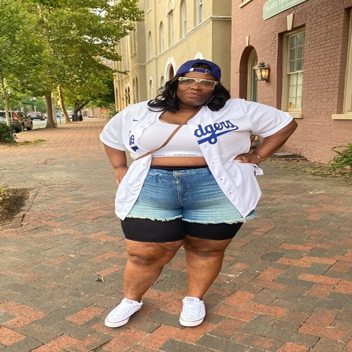 Reviewer wearing the white bralette with a Dodgers shirt and jean shorts