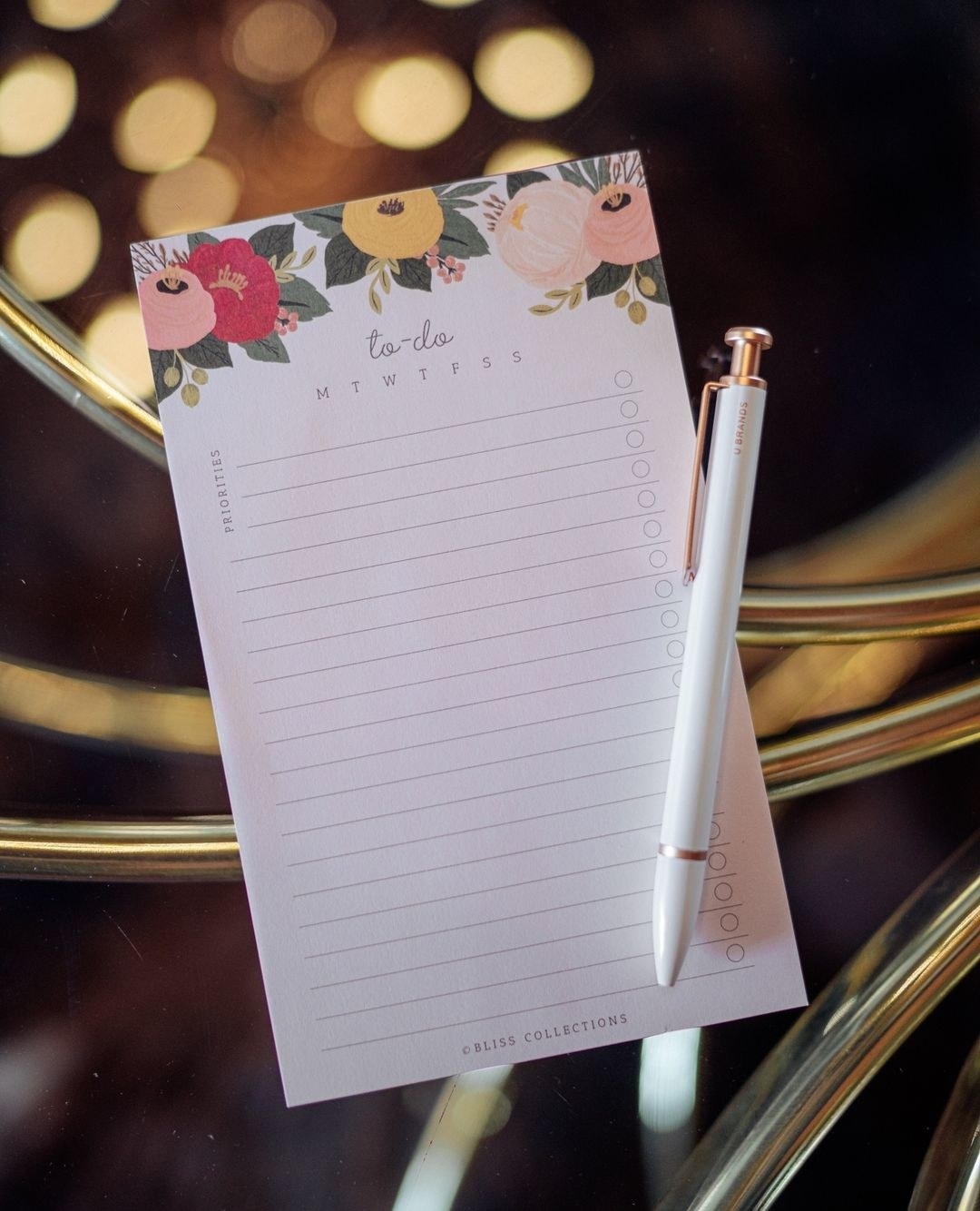 The floral notepad on a glass table