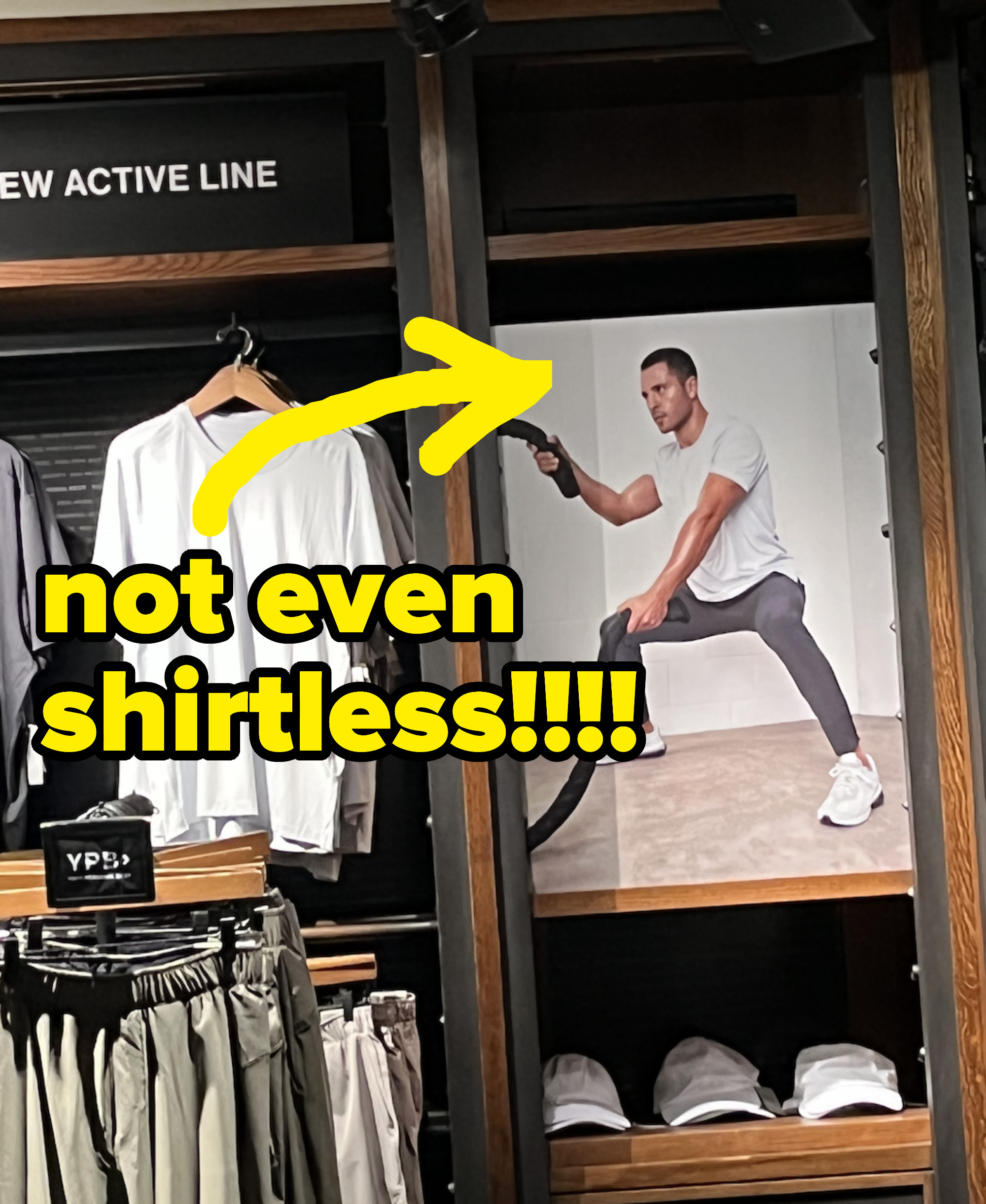 An arrow pointing to a photo of a man working out amid clothing displays with the text &quot;not even shirtless!!&quot;